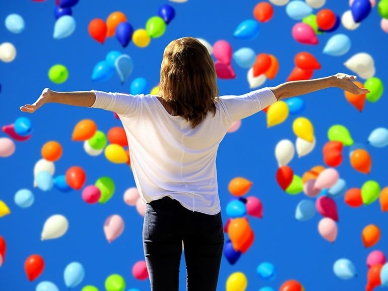 This shows a woman and balloons