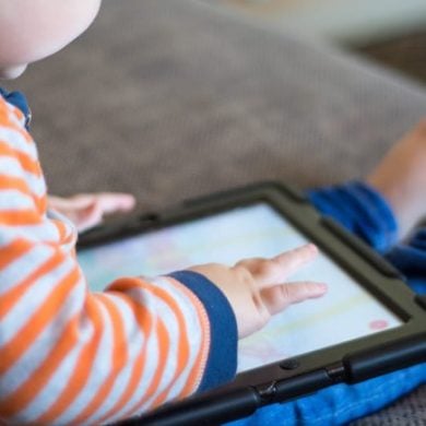 This shows a toddler with a tablet