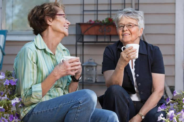 This shows two older ladies having a cup of tea