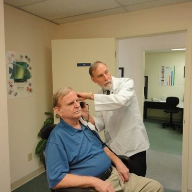 This shows a man getting a hearing test