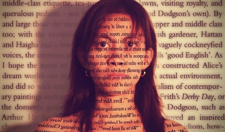 This shows a woman with her face covered in text