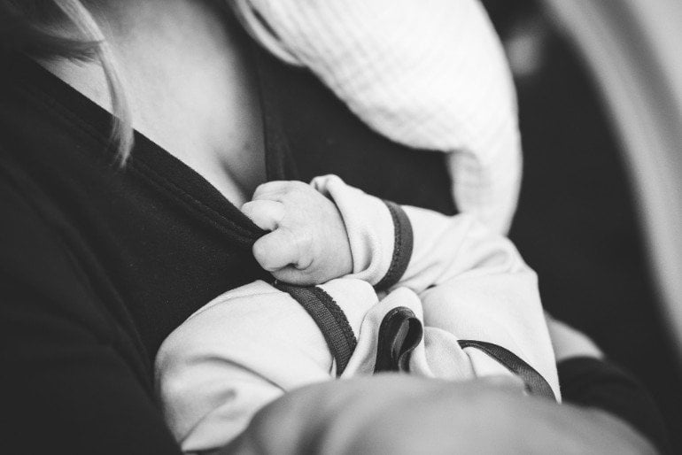 This shows a mom feeding a baby