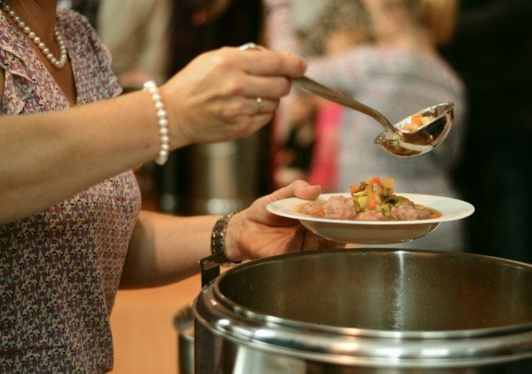 This shows a woman dishing out food