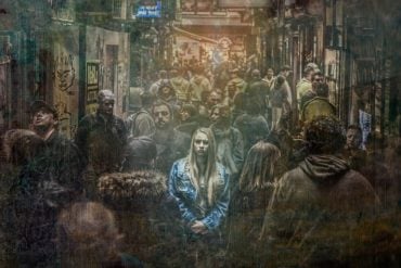 This shows a scared looking woman in a crowd