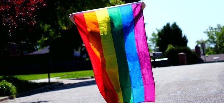 This shows a person with a rainbow flag