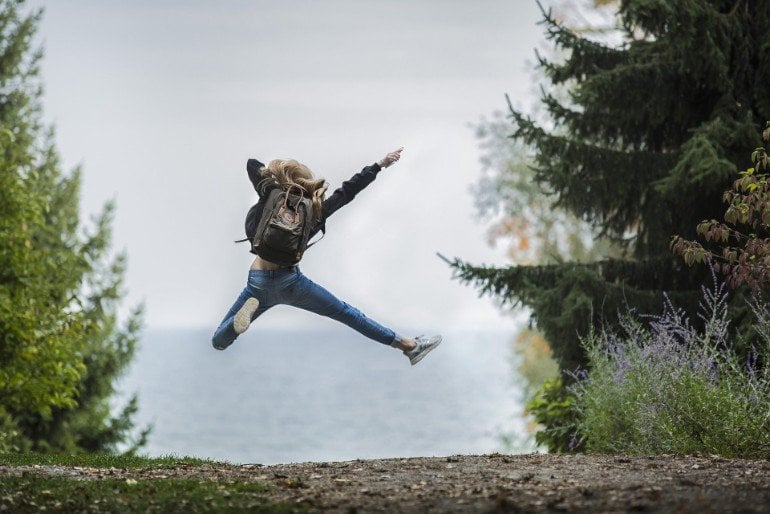 This shows a woman jumping for joy