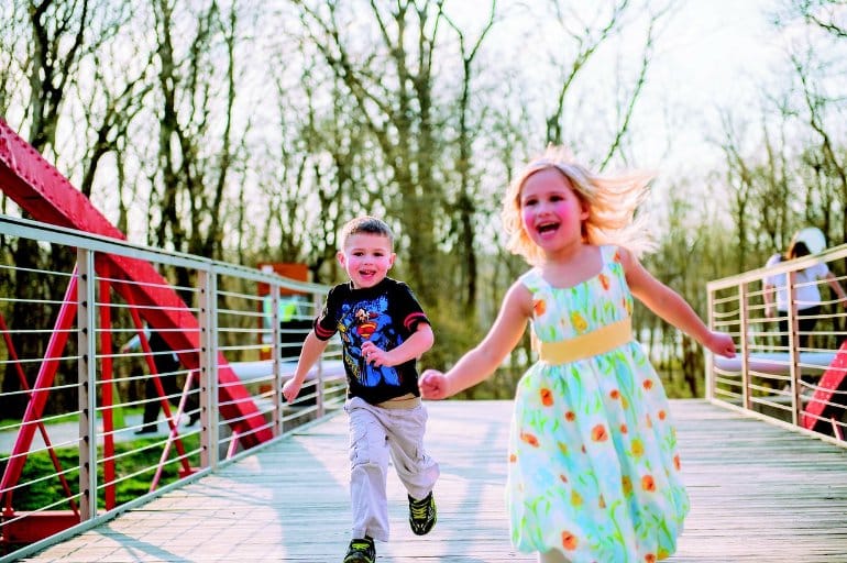 This shows a little boy and girl running and having fun