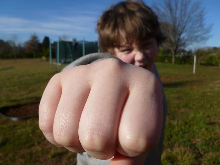This shows a kid making a fist