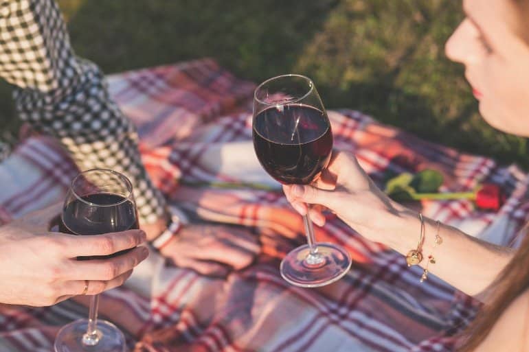 This shows a lady enjoying a glass of red wine