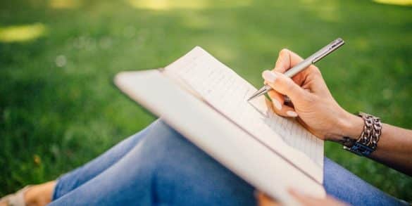 This shows a woman writing in a journal