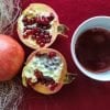 This shows a pomegranate and a mug of juice