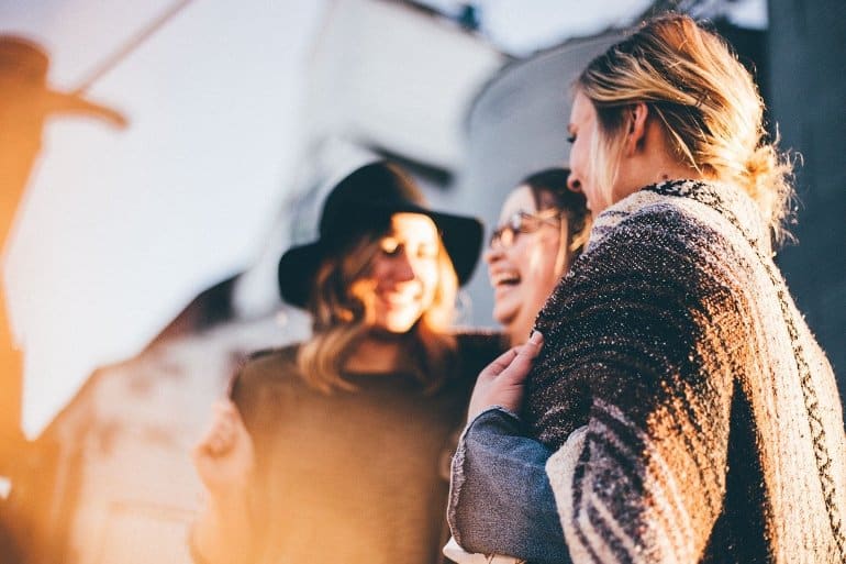 This shows a group of women chatting and laughing