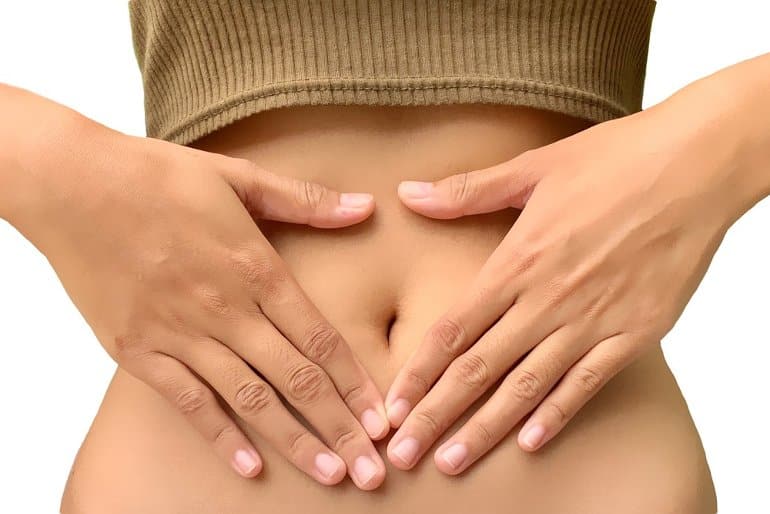 This shows a woman with her hands on her tummy