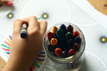 This shows a child coloring in