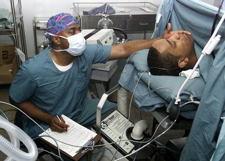 This shows an anesthesiologist taking care of a patient while under anesthetic