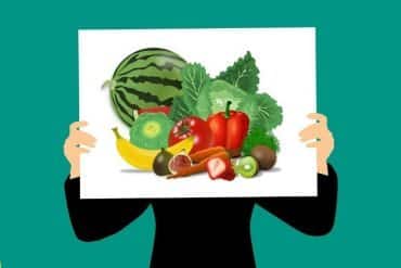 This is a cartoon of a person holding up a poster of fruit and veg