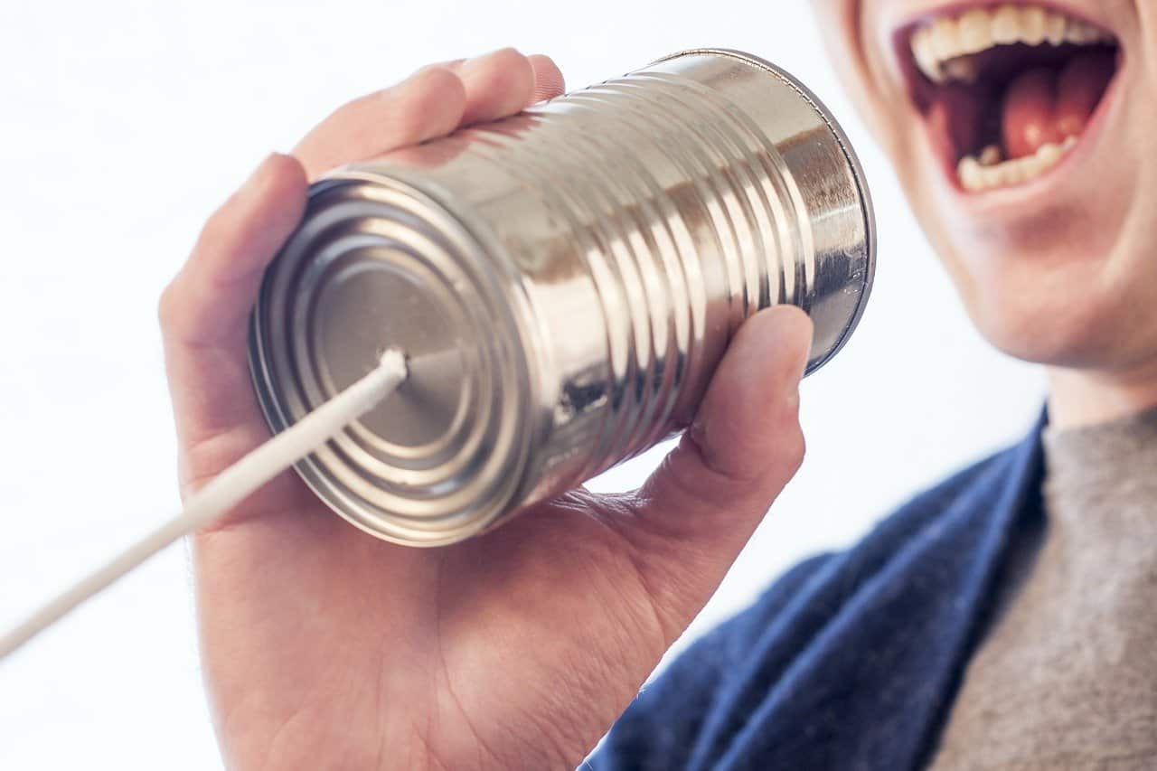 This shows a man yelling into a tin can "telephone"