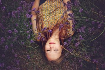 This shows a woman sleeping in a lavender field