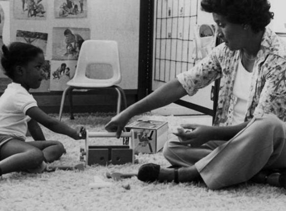 This shows a little girl playing with her teacher