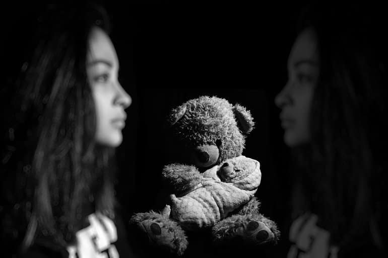 This shows a woman and a teddy bear