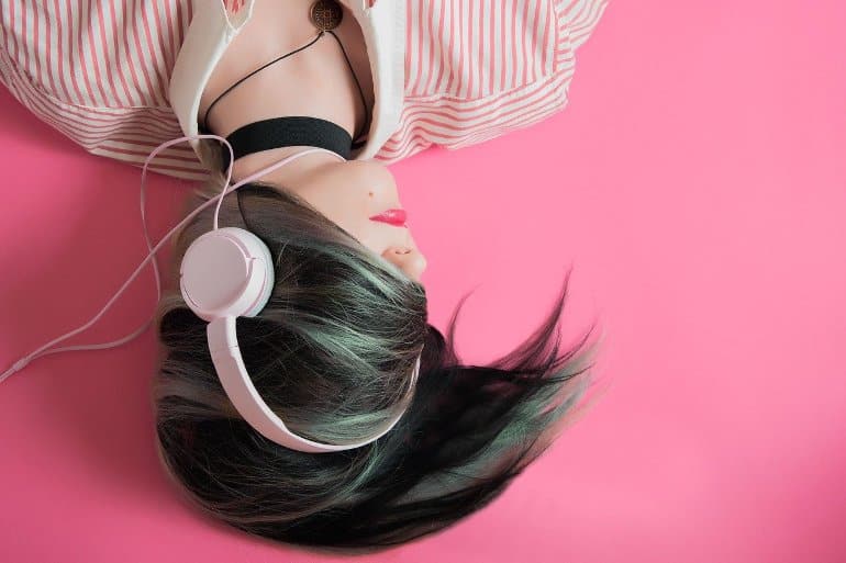 This shows a woman listening to music on headphones
