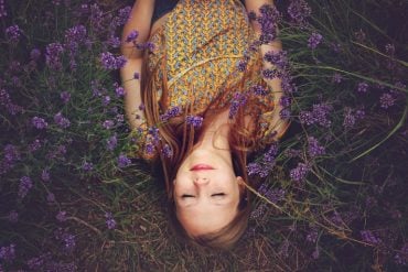This shows a woman sleeping in a lavender field