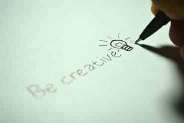 This shows a piece of paper with "be creative" and a lightbulb drawn on it