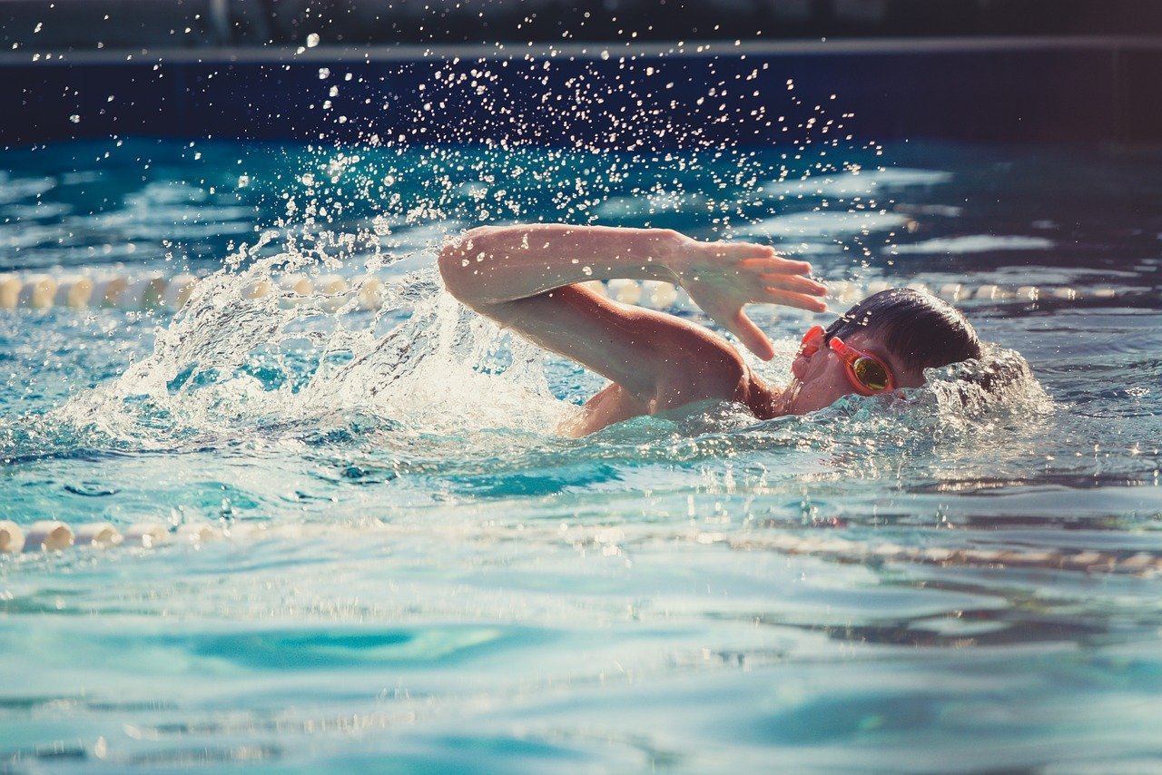 This shows a little boy swimming