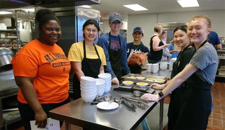 This shows students prepping in a kitchen