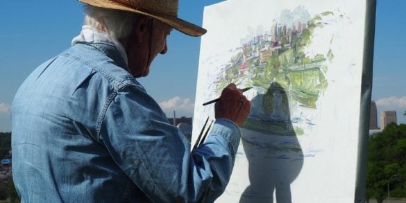 This shows an older man painting