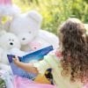 This shows a little girl reading to her toys
