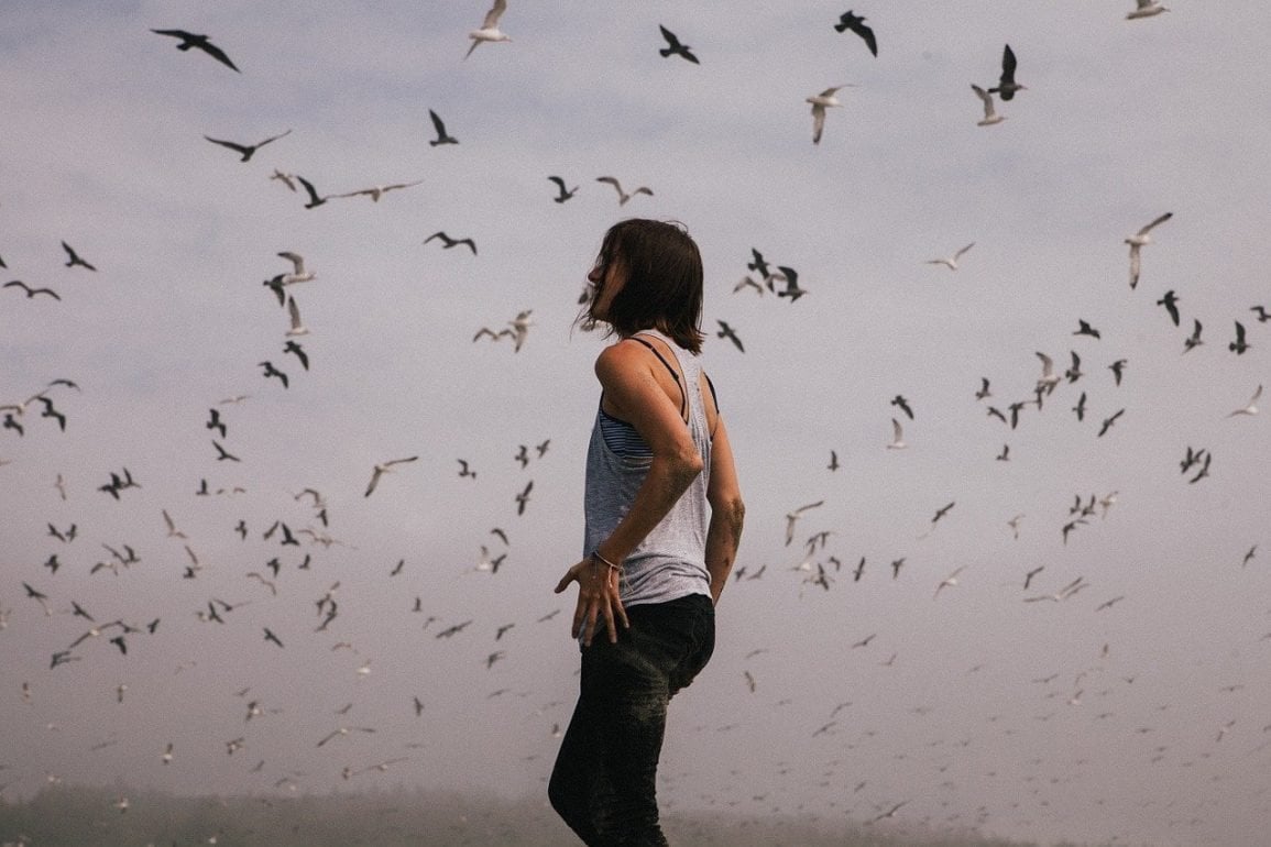This shows a woman surrounded by birds