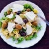 This shows a pasta salad with olives and feta cheese