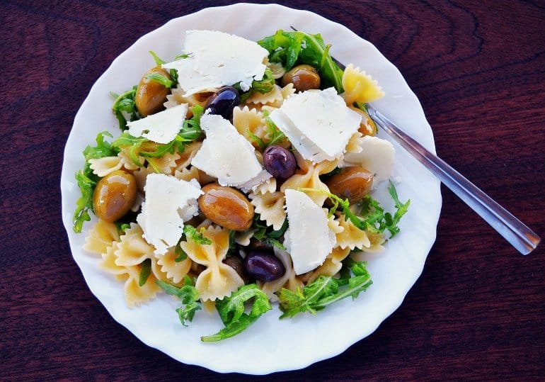 This shows a pasta salad with olives and feta cheese