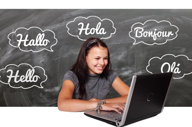 This shows a woman at a computer with bubbles around her that have "hello" written in different languages