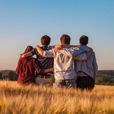 This shows a group of friends in a field