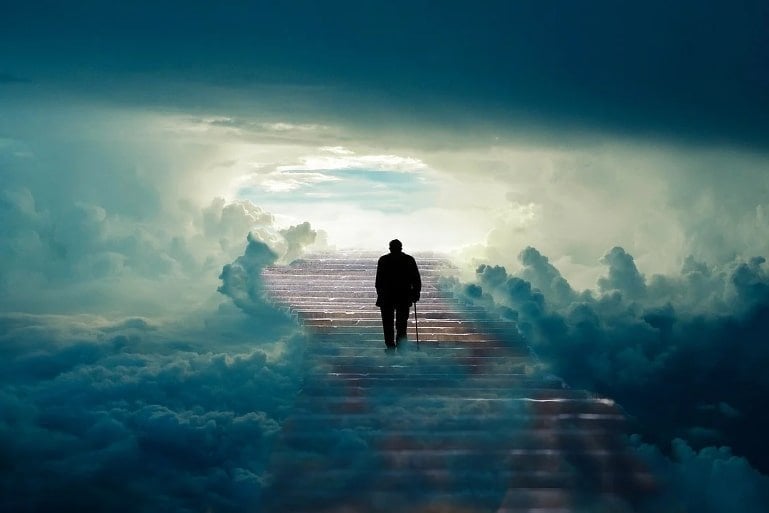 This shows an old man walking up a staircase surrounded by thick clouds