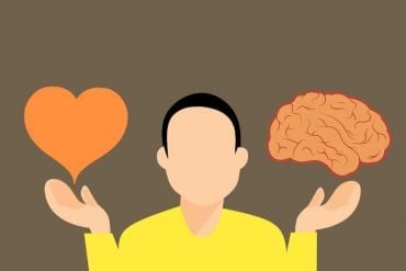 This is a cartoon of a man holding a heart and a brain