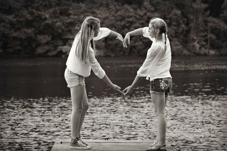 This shows two girls at a lake