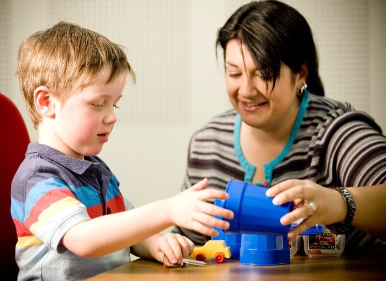 This shows the researcher playing a cup game with a little boy