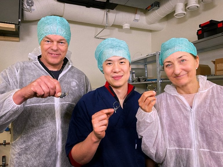 This shows the researchers holding up the microscope