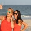This shows two women taking a selfie on a beach