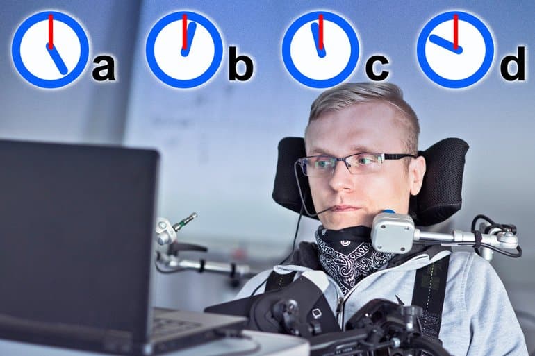 This shows a man in a wheel chair sitting at a computer