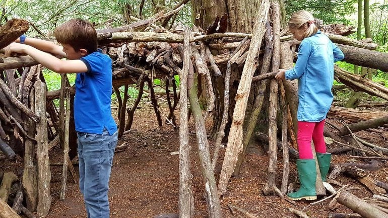 This shows children building a fort