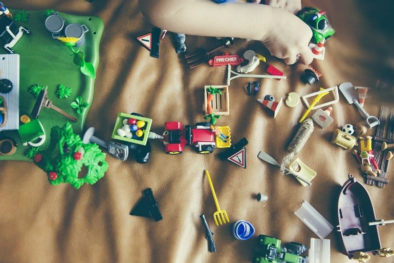 This shows a child playing with small toys