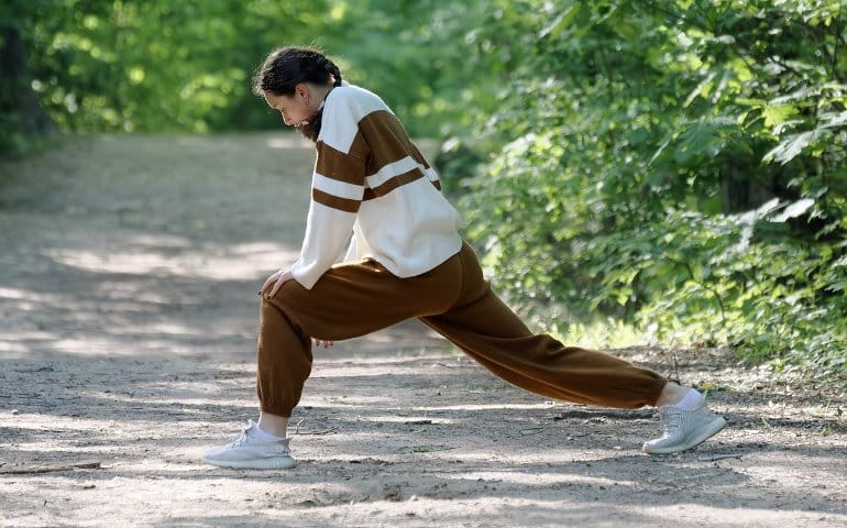 This shows a woman stretching for a run