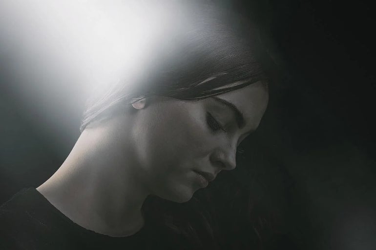 This shows a woman surrounded by a white light