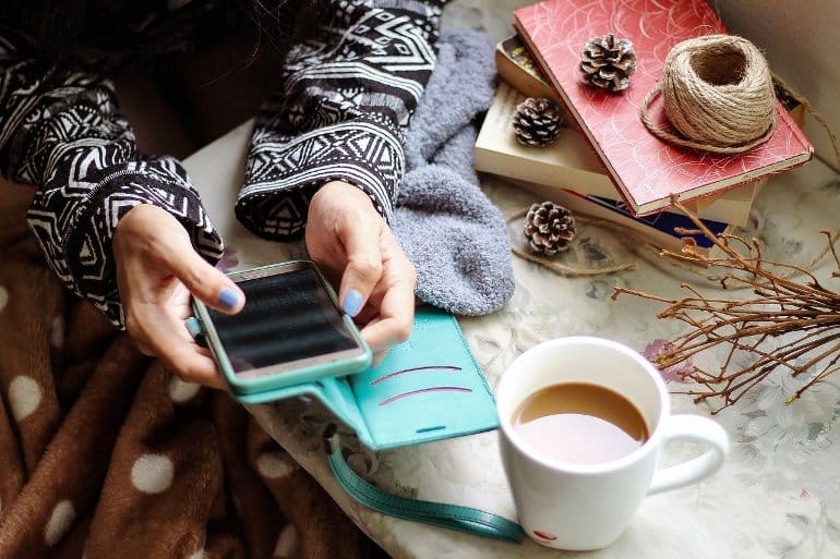 This shows a woman checking social media on a phone