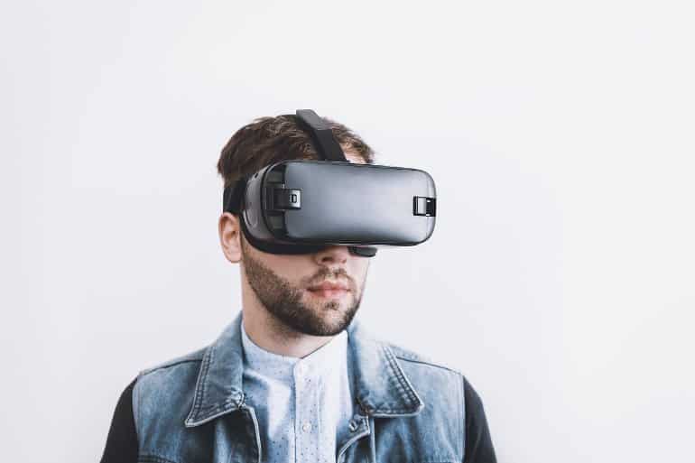 This shows a man wearing VR glasses
