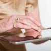This shows an older lady using a tablet